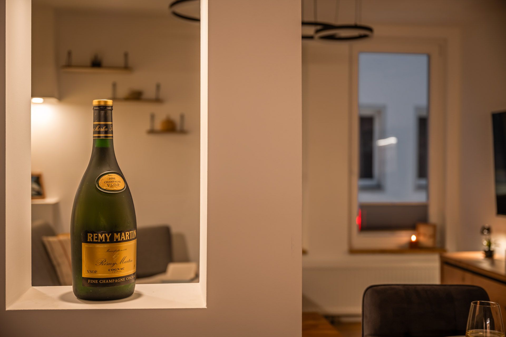 Stylish detail with a cognac bottle in the wall niche