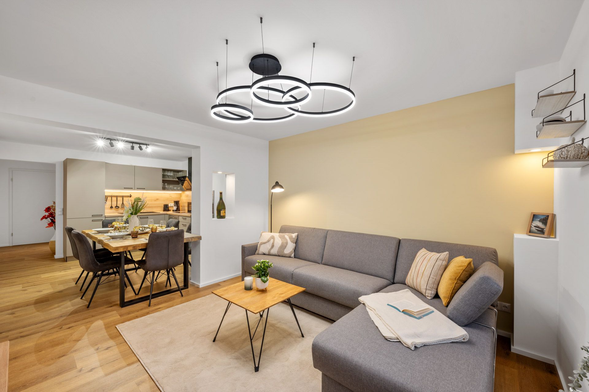Open living-dining area with a round pendant light and sofa