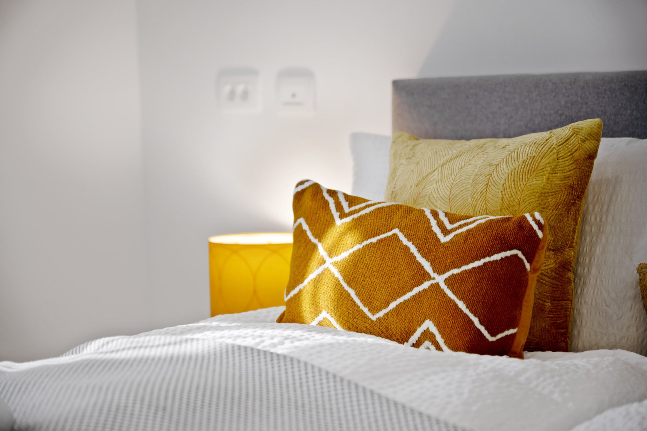 Close-up of decorative cushions on the bed