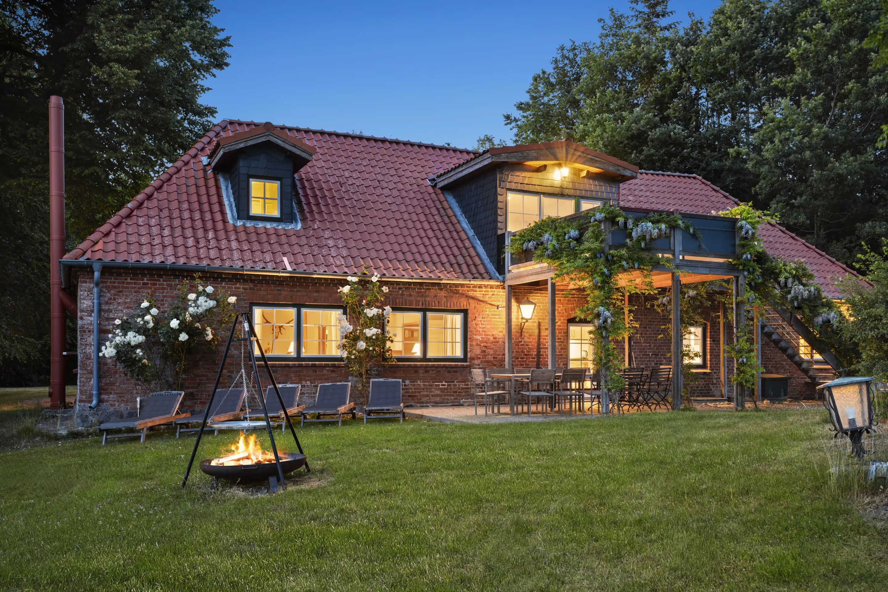Bakehouse in the evening with a fire pit in the garden