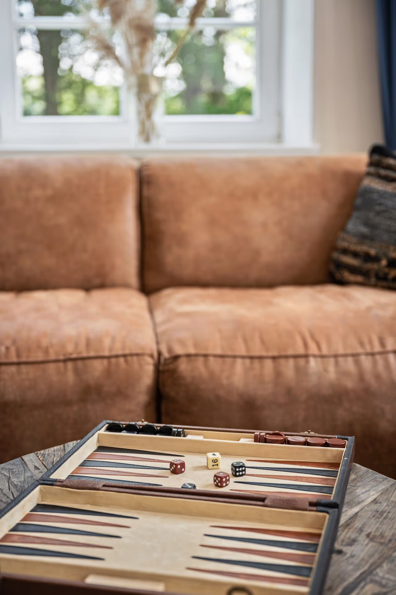 Leather sofa with a backgammon game on the table