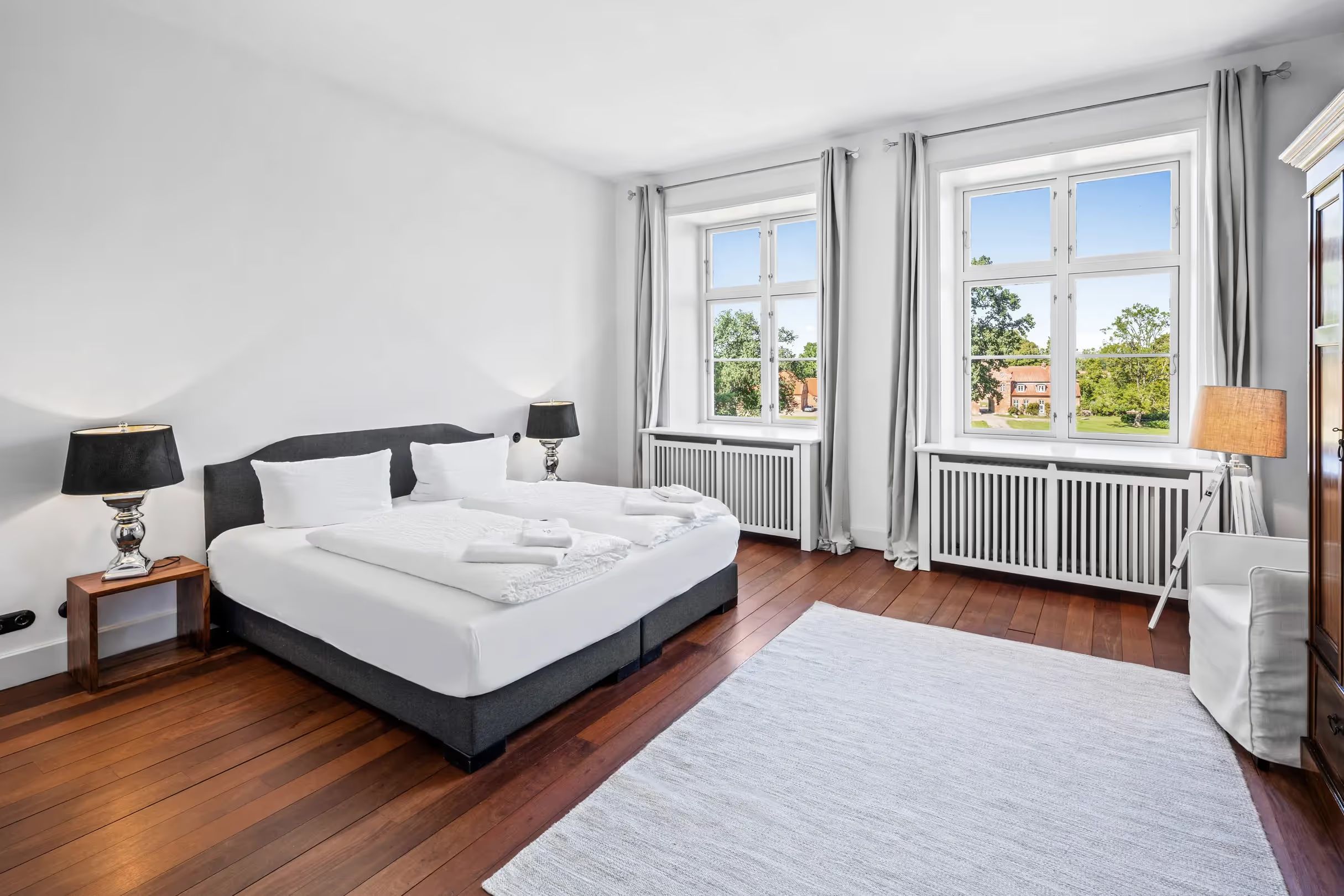 Bedroom with a double bed and tall windows