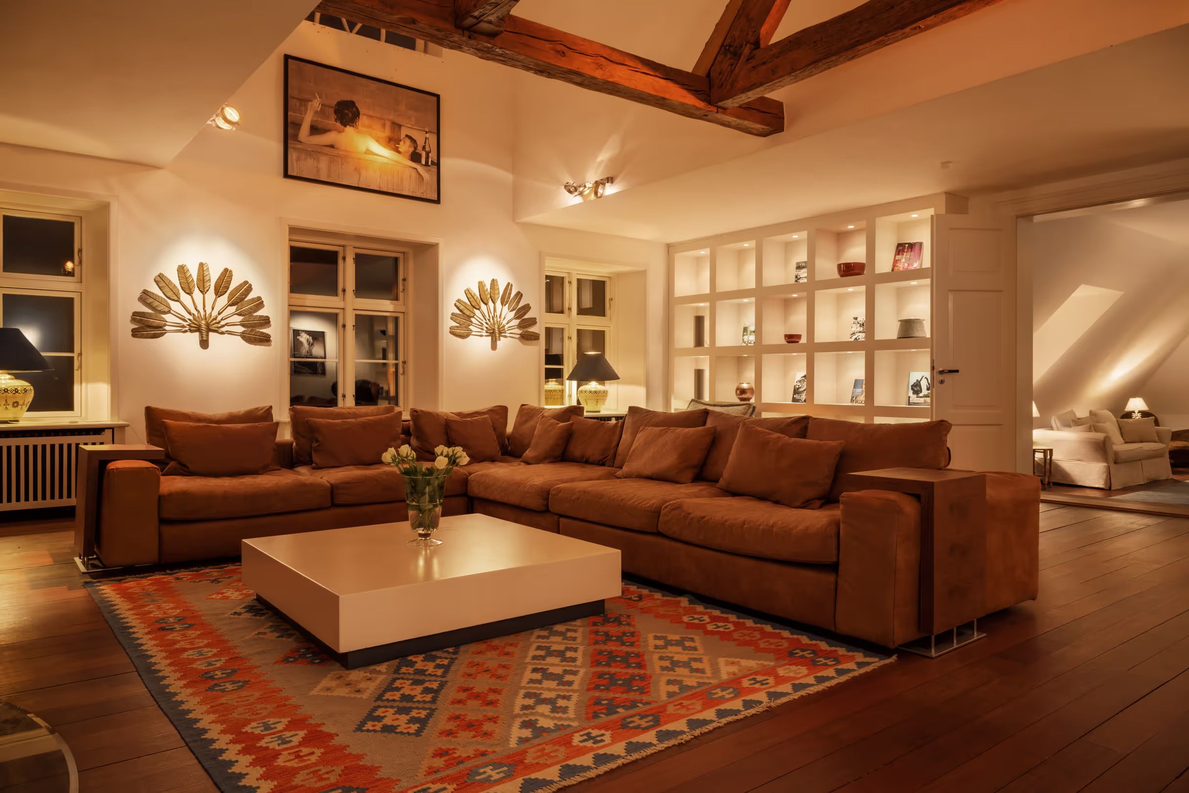 Living room with a sofa arrangement beneath open roof beams