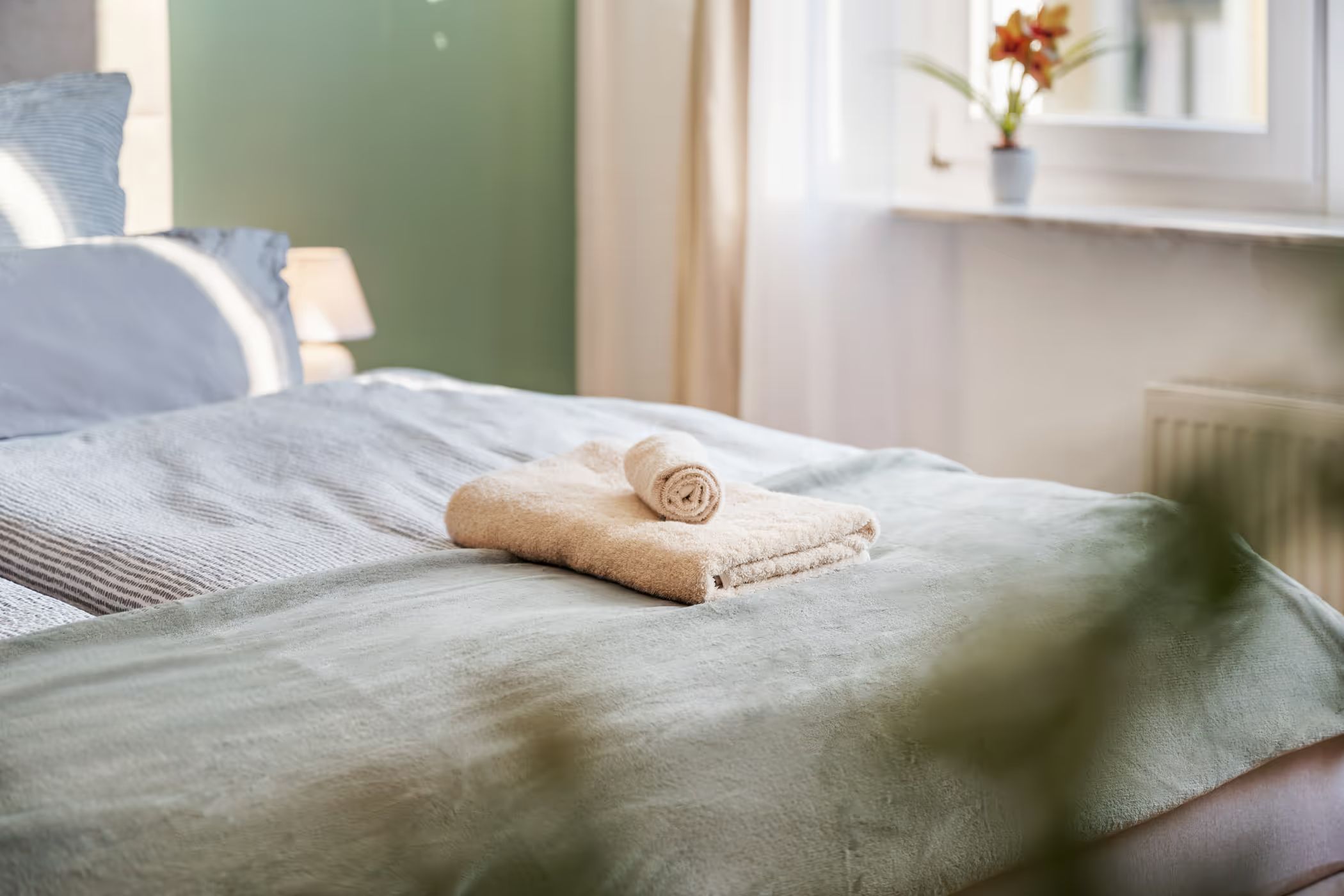 Bed with folded towels, close-up detail