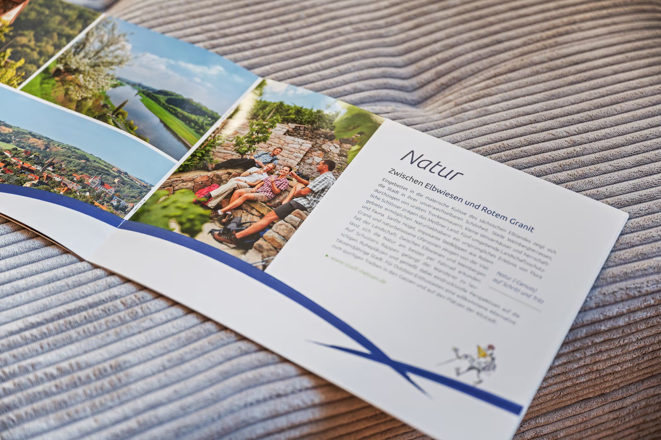 Open travel brochure with nature photos