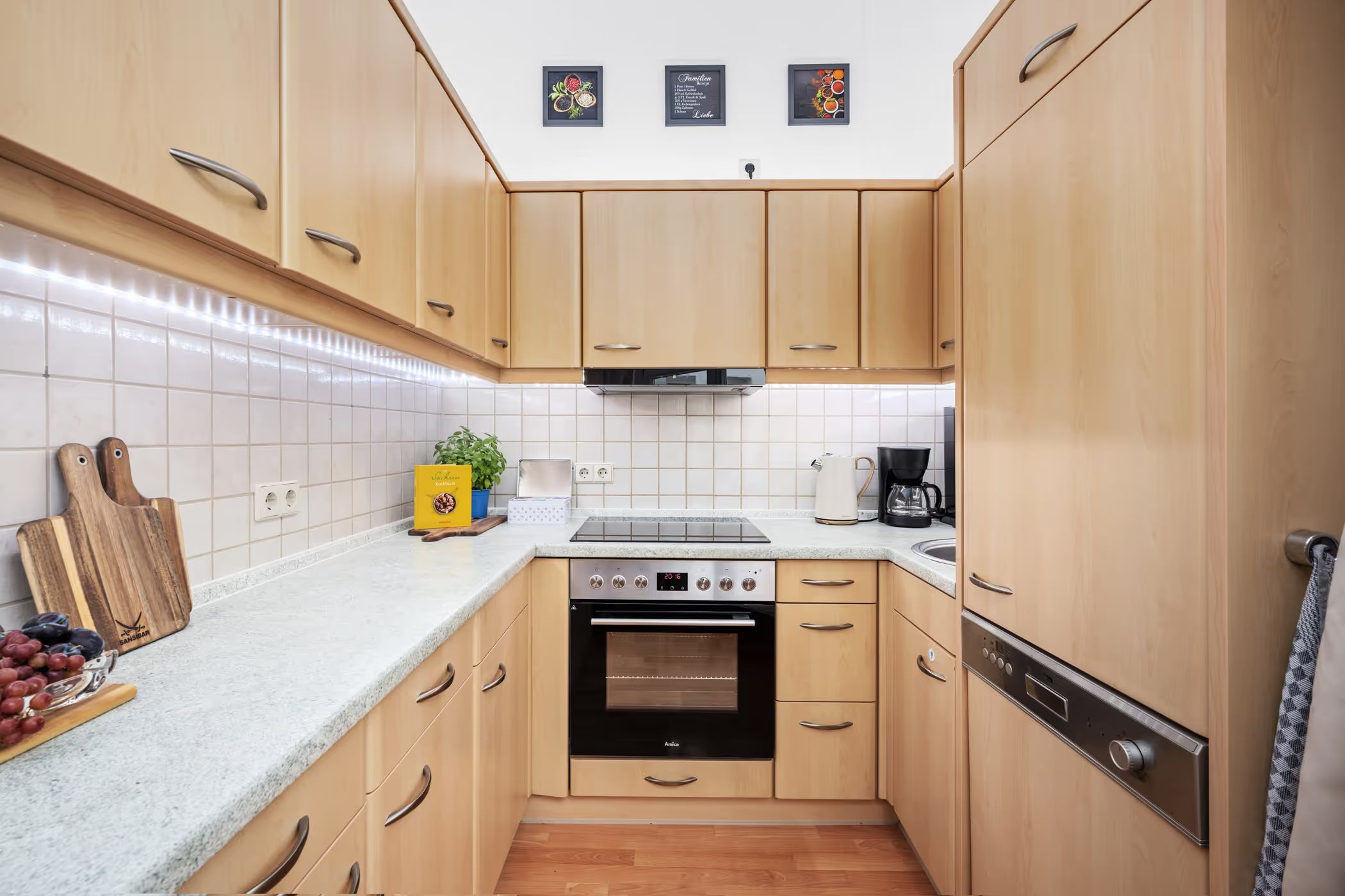 Kitchen with wood fronts and built-in appliances