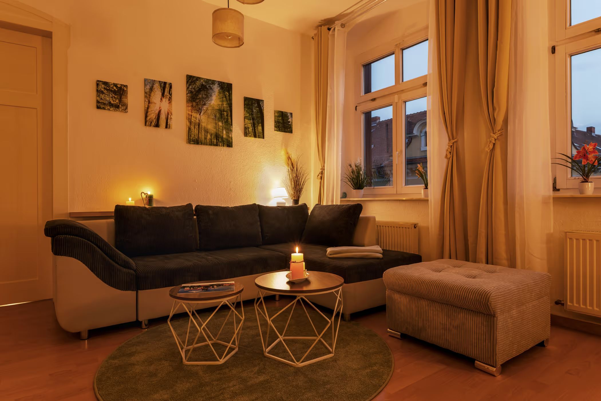 Living room with sofa in a cozy evening mood