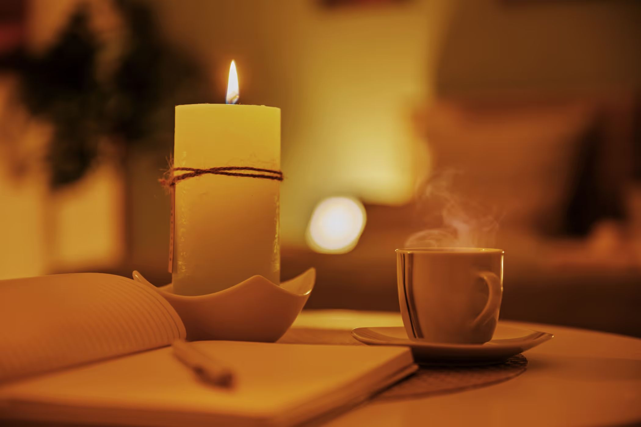 Candle and coffee cup, a cozy detail