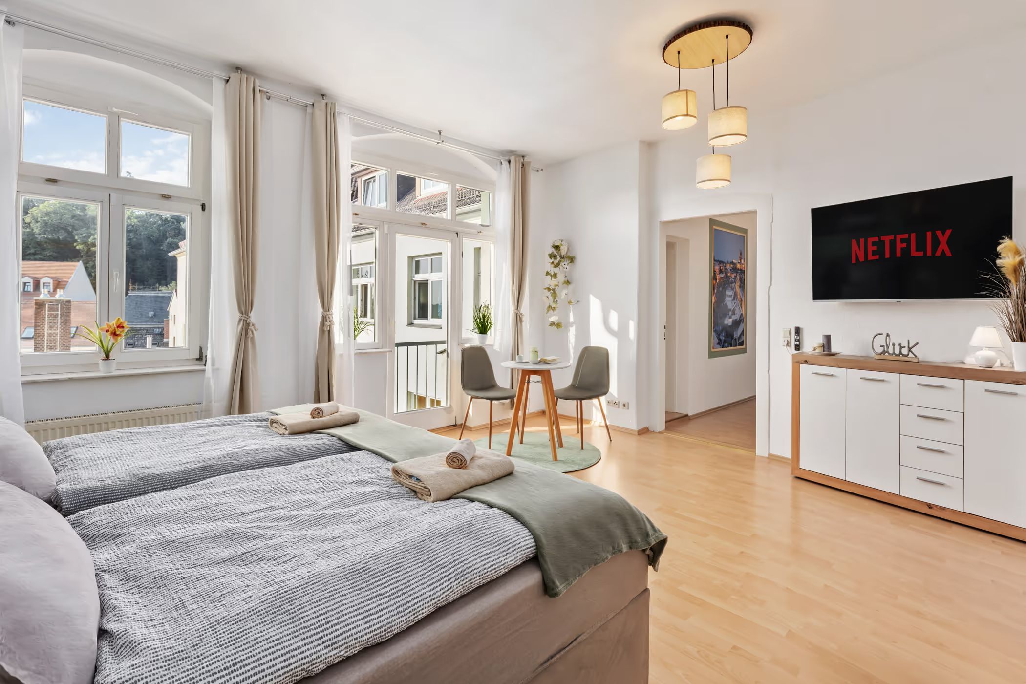 Studio with bed, dining table and television