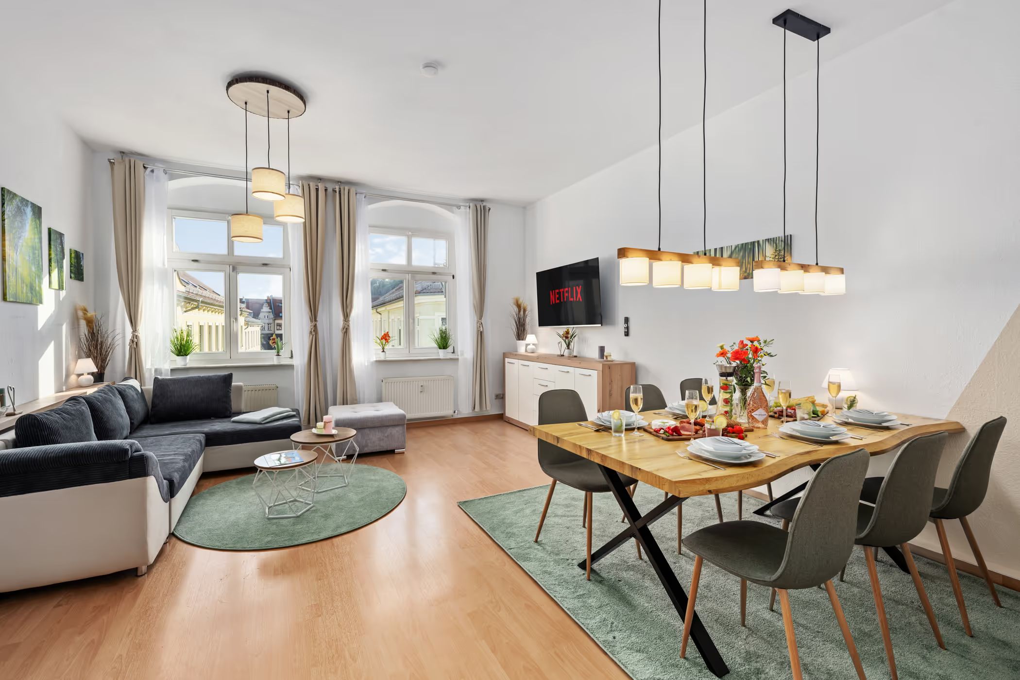 Dining area with a set table and pendant lights