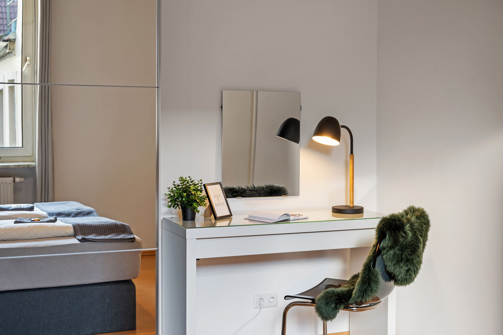 Vanity table with a mirror and cozy armchair