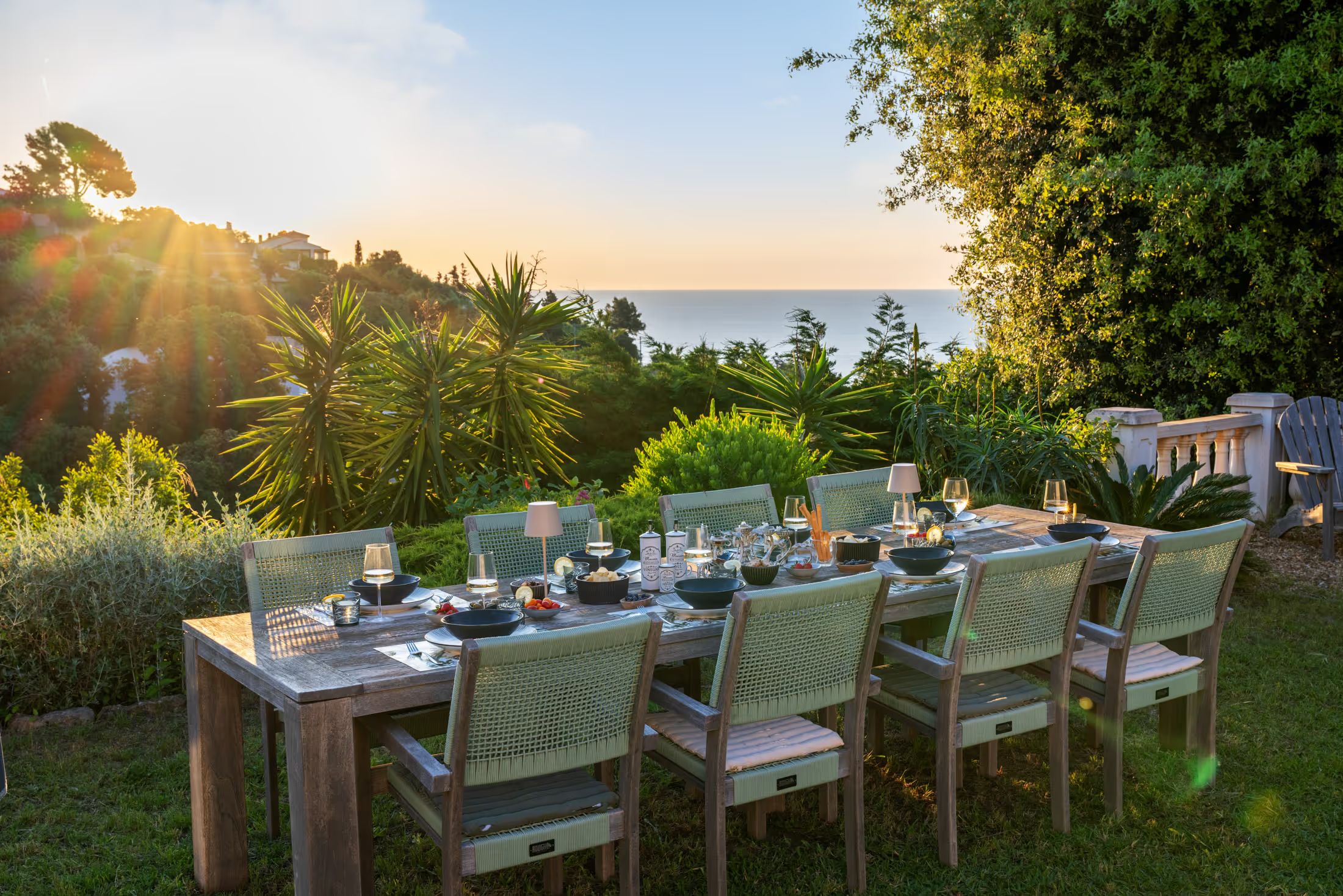 Set garden table with sea view at sunset