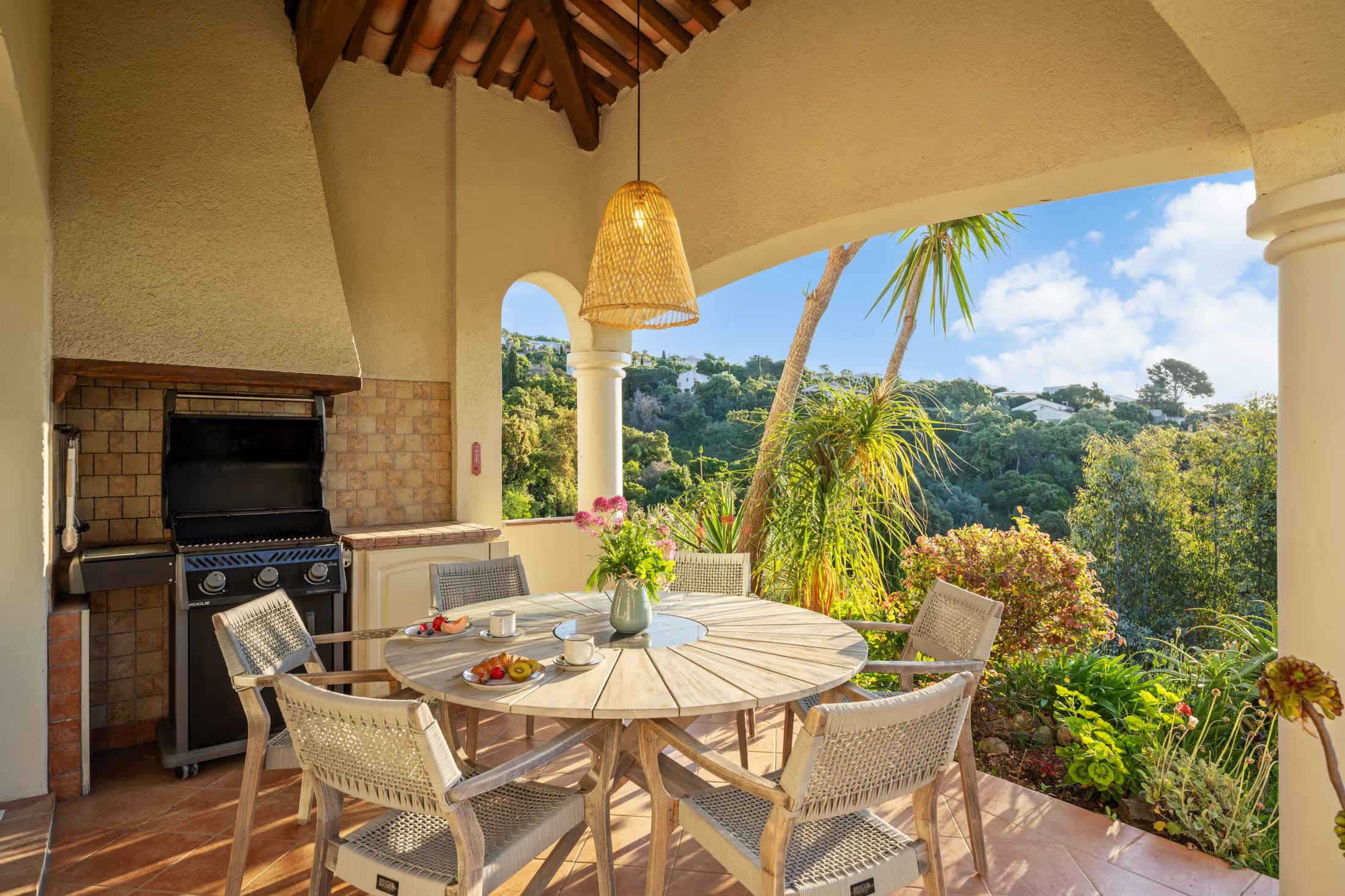 Outdoor kitchen with a set table on the terrace