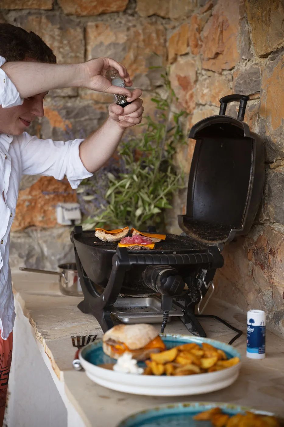 Man grilling burgers on an outdoor grill