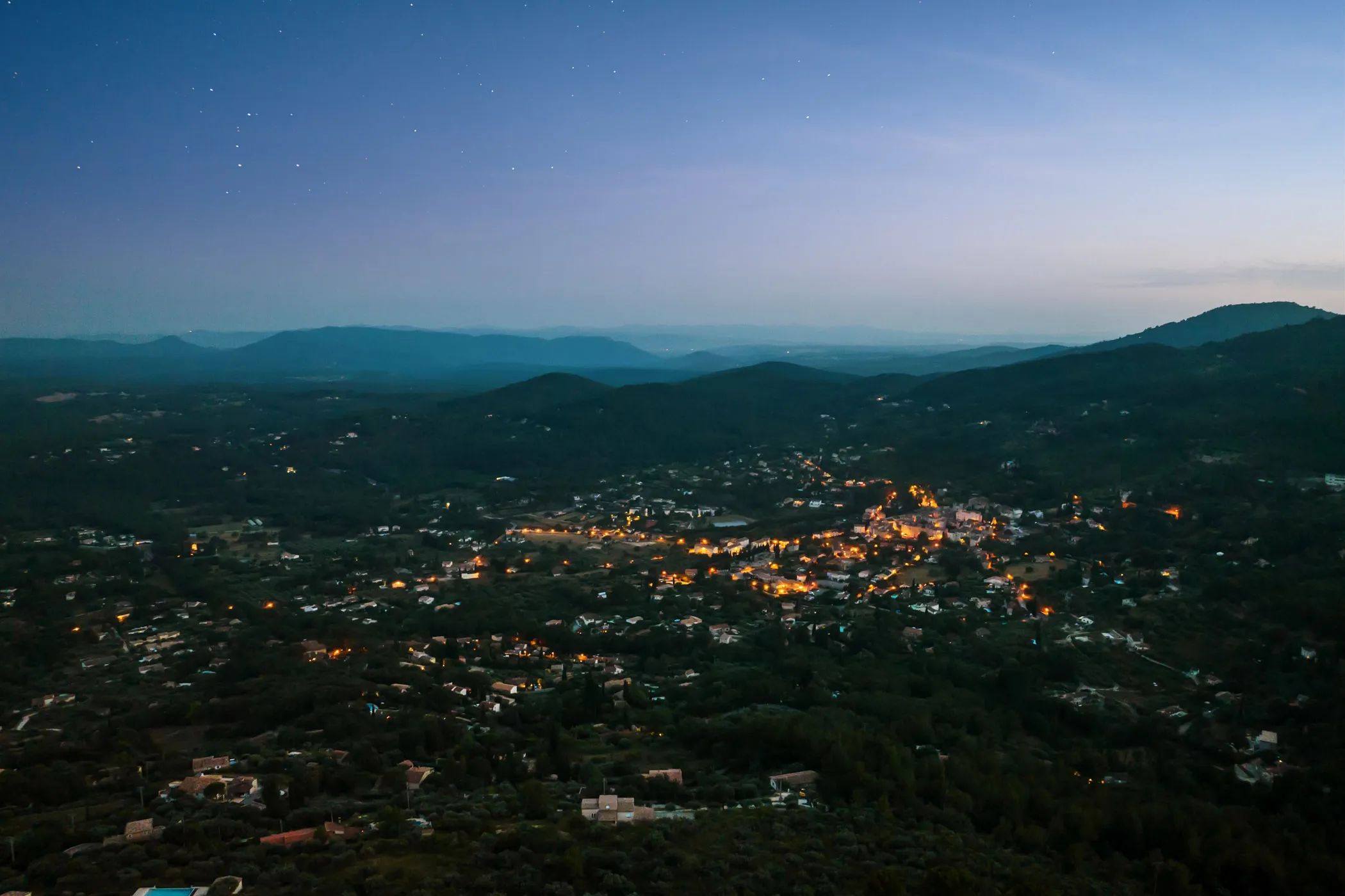 Nighttime view of the valley under a starry sky