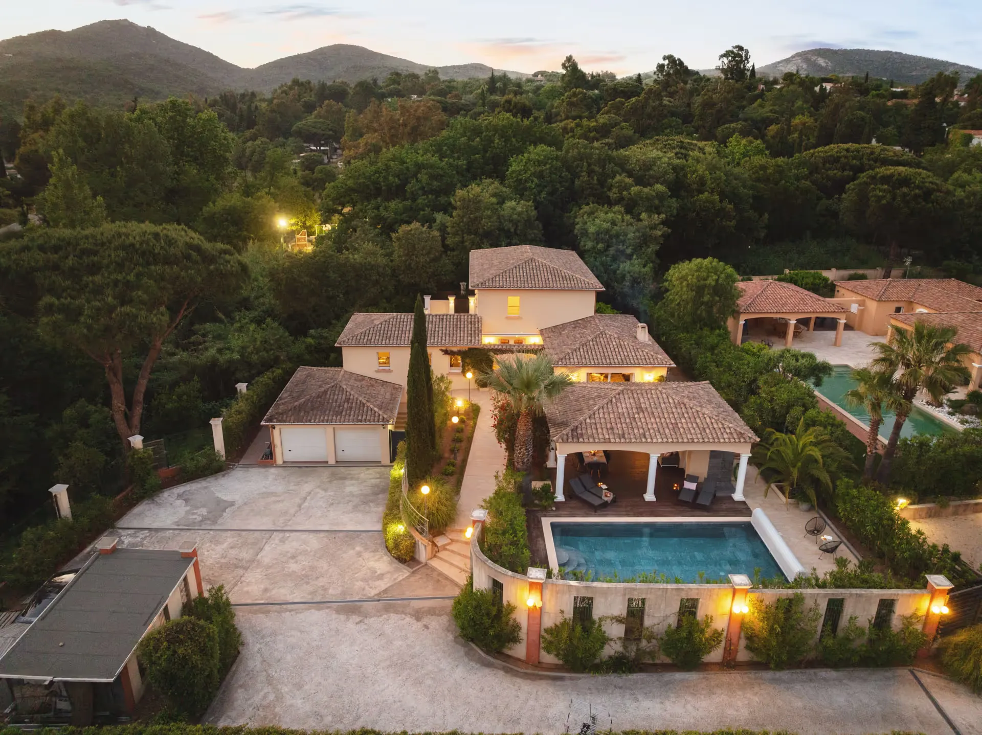 Aerial view of the villa with pool at dusk