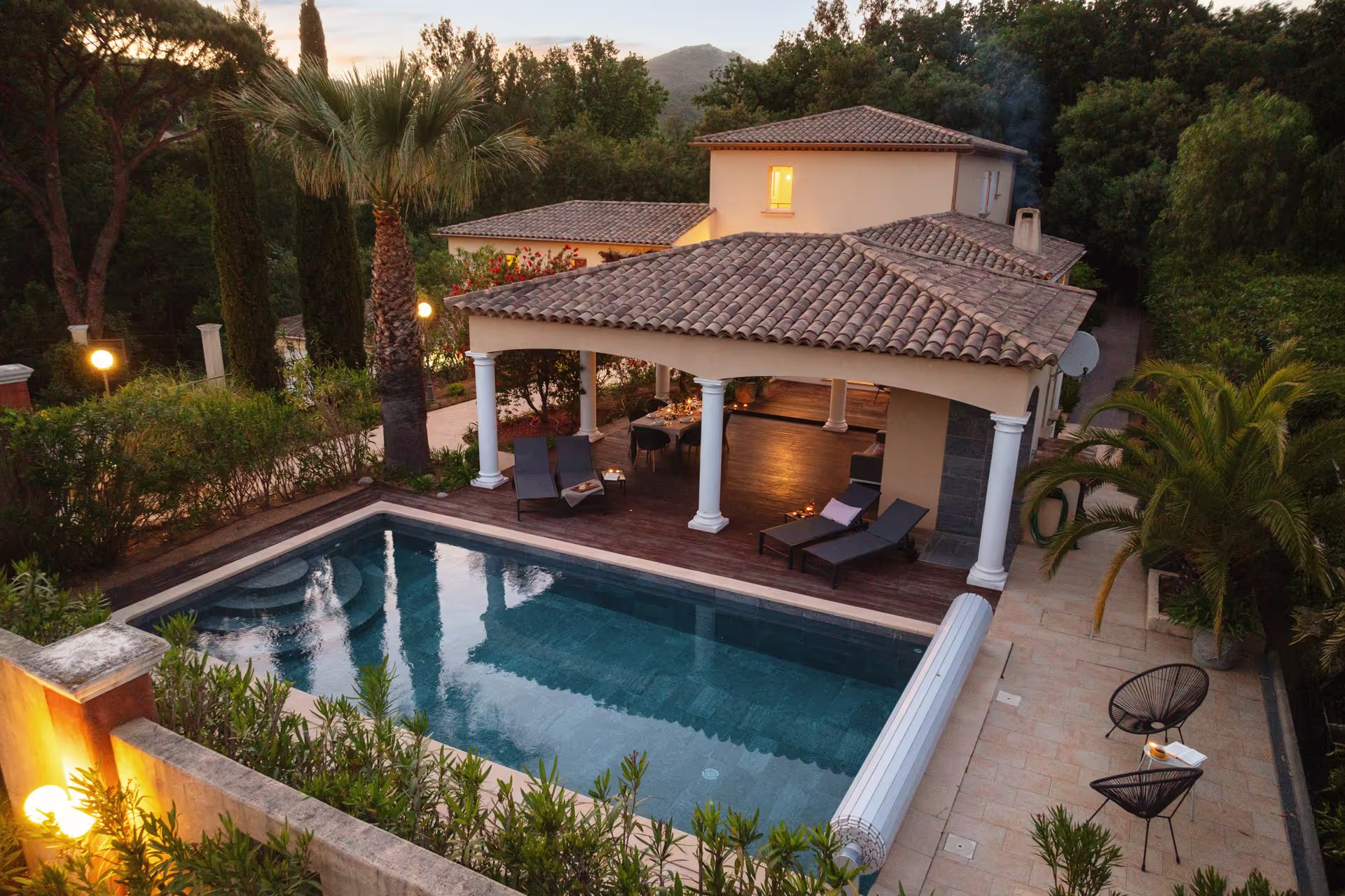 Pool and villa from a bird's-eye view at dusk