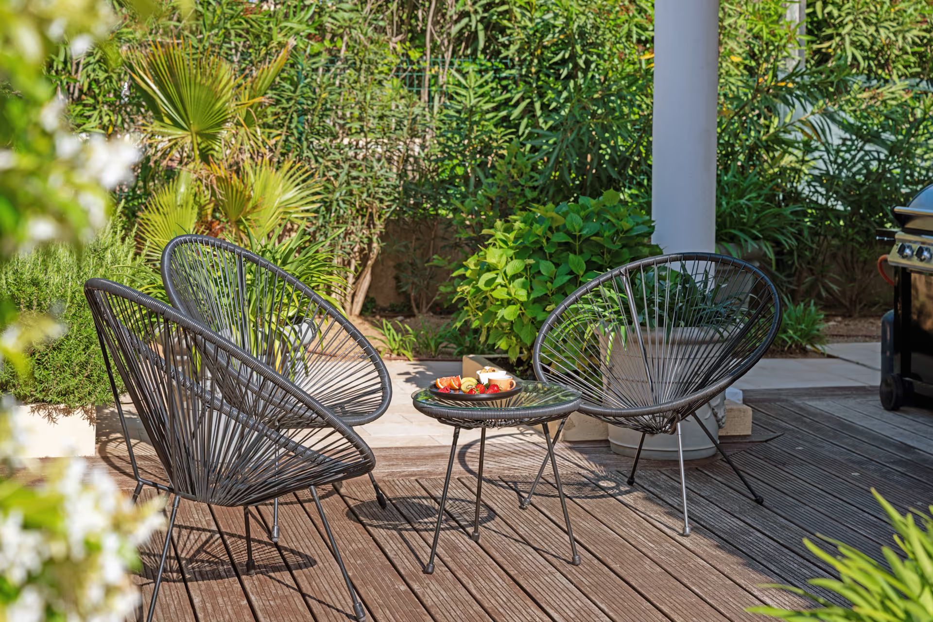 Seating area on the terrace surrounded by greenery